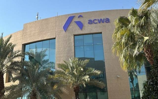 An ACWA office building bearing the company's logo, surrounded by palm trees