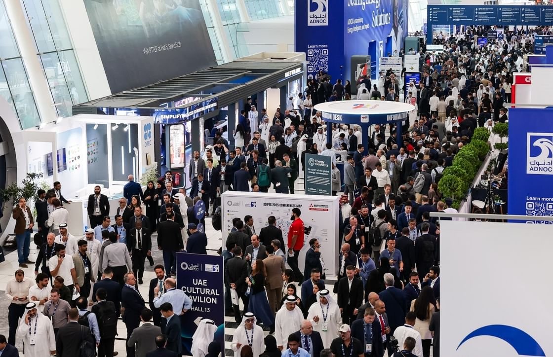 Visitors walk through a crowded exhibition hall at ADIPEC in Abu Dhabi
