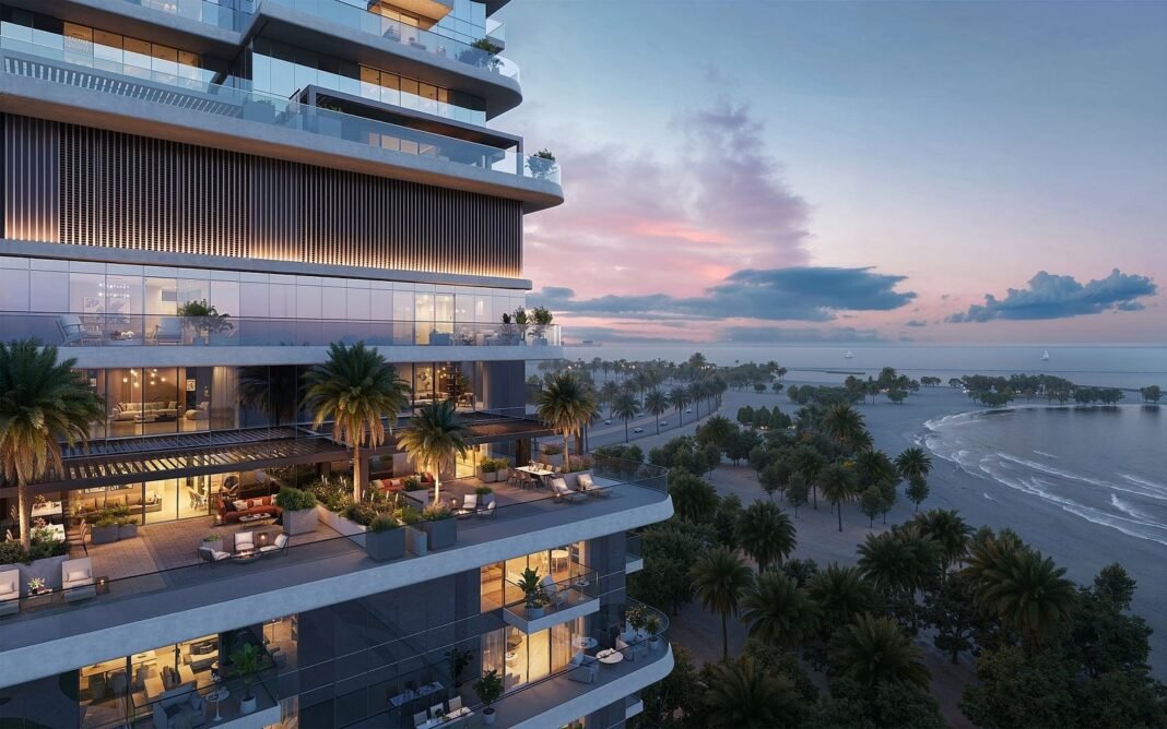 Rendering of a waterfront residential tower with terraces overlooking a palm-lined beach on Al Marjan Island