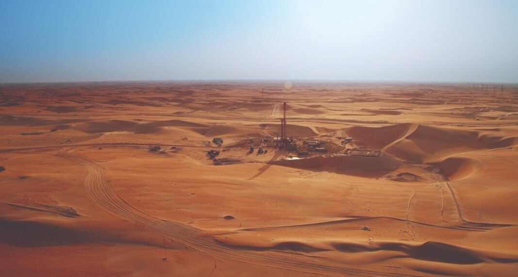 An ADNOC Drilling onshore rig among sand dunes in the UAE desert