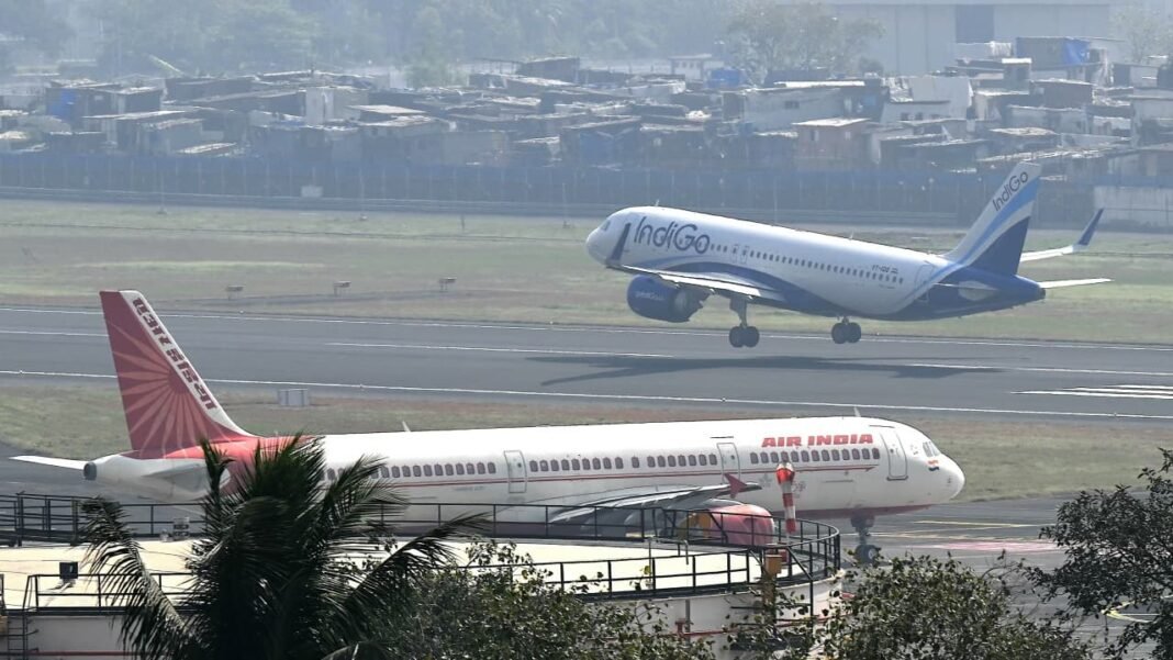 An Air India aircraft taxis as an IndiGo plane takes off at an Indian airport