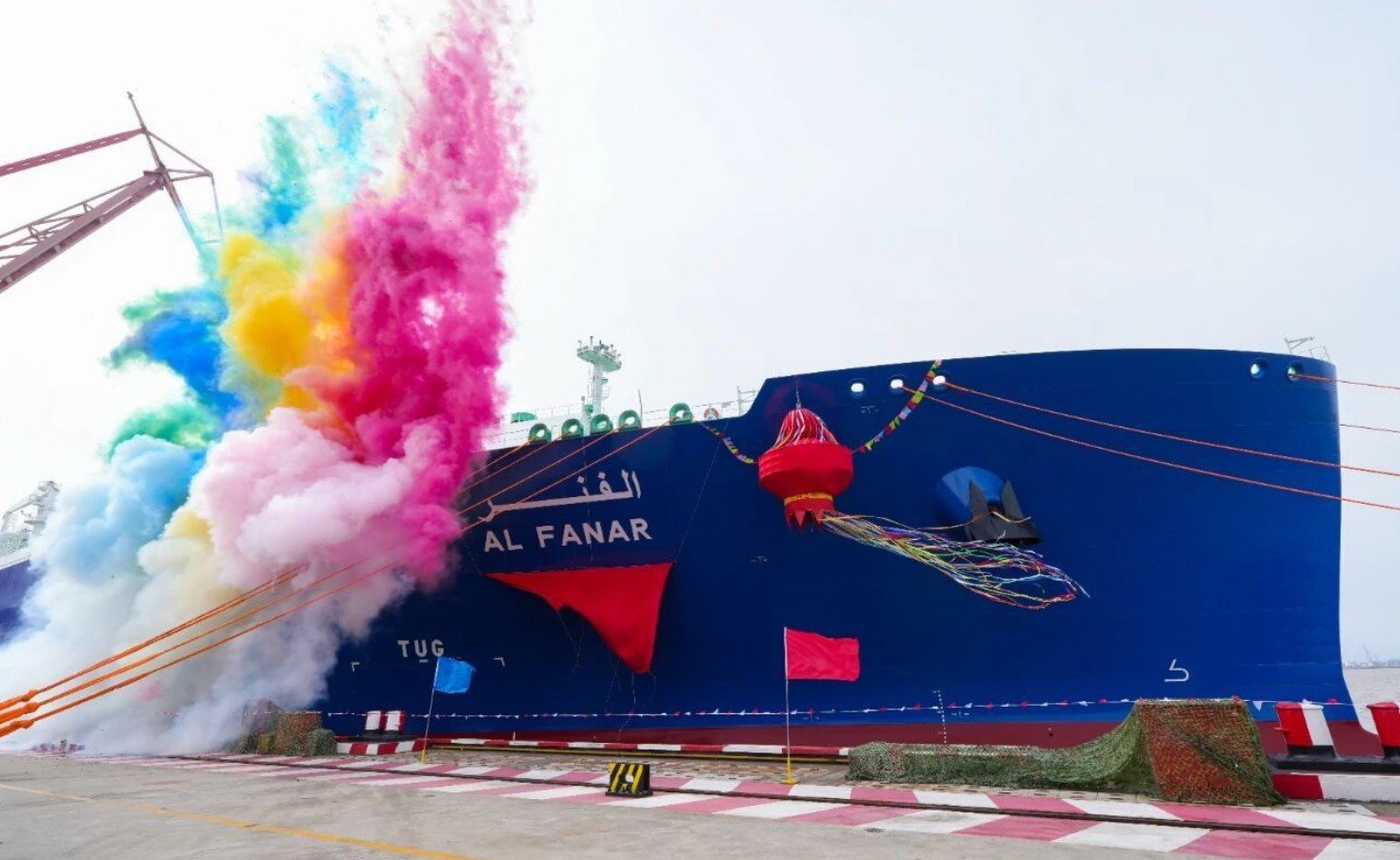 Blue hull of the LNG carrier Al Fanar with its name in English and Arabic during a naming ceremony at a Shanghai shipyard