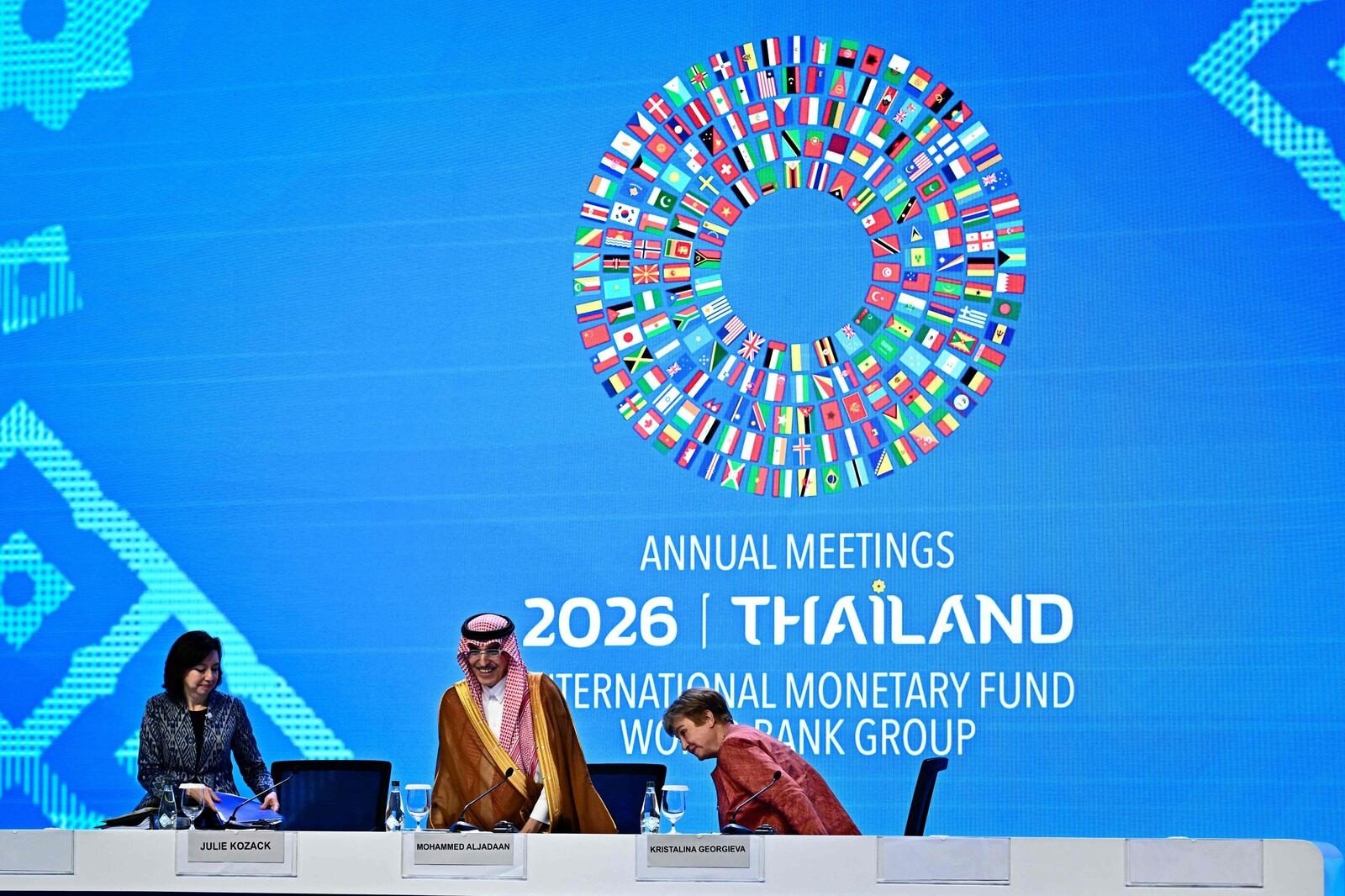 Mohammed Al-Jadaan and Kristalina Georgieva take their seats at a news conference table in front of the IMF and World Bank 2026 Annual Meetings Thailand backdrop