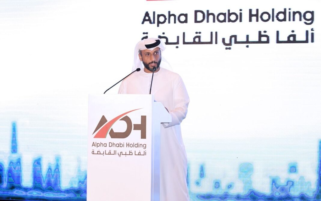 Hamad Al Ameri, managing director and group CEO of Alpha Dhabi Holding, speaks at a podium bearing the company's name
