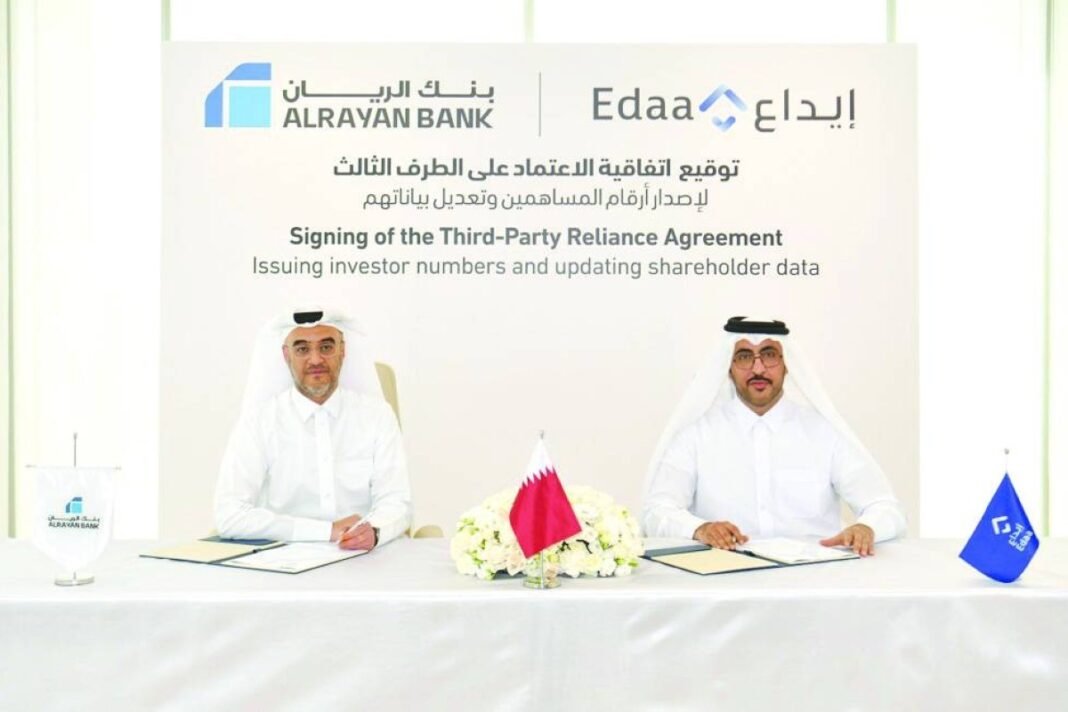 AlRayan Bank and Edaa officials seated at a signing table with a Qatari flag between them