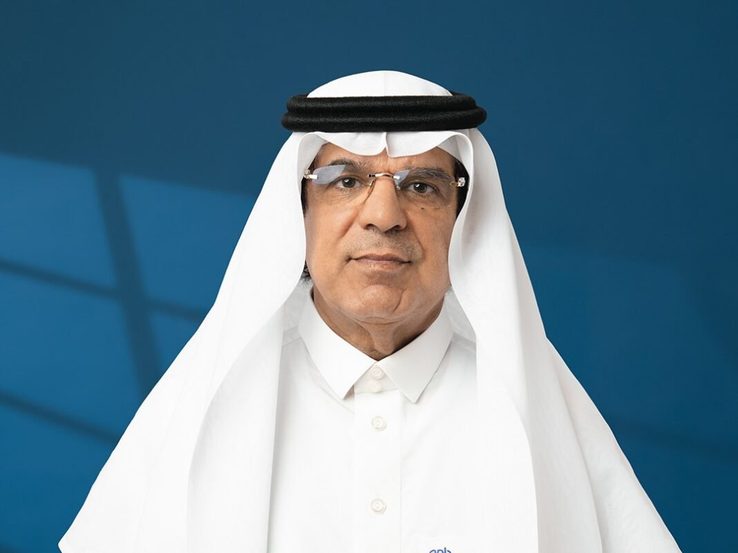 Portrait of Arab National Bank Chief Executive Officer Obaid Alrasheed in a white thobe and ghutra against a blue background