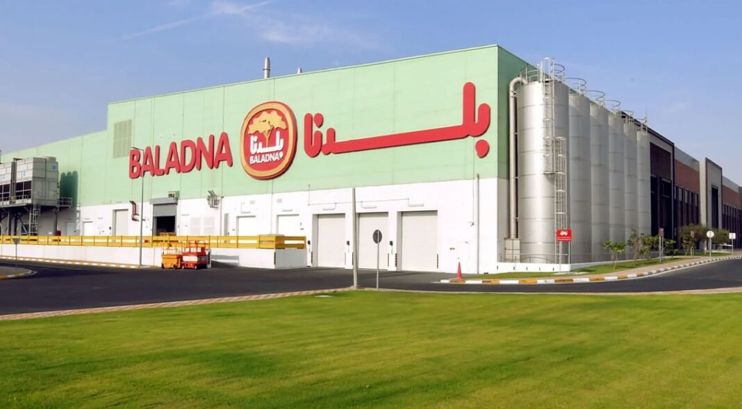 Baladna dairy production plant in Qatar with the company name on the facade and steel silos