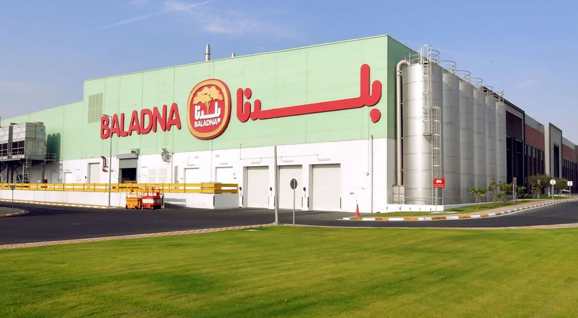 Baladna dairy production plant in Qatar with the company name on the facade and steel silos