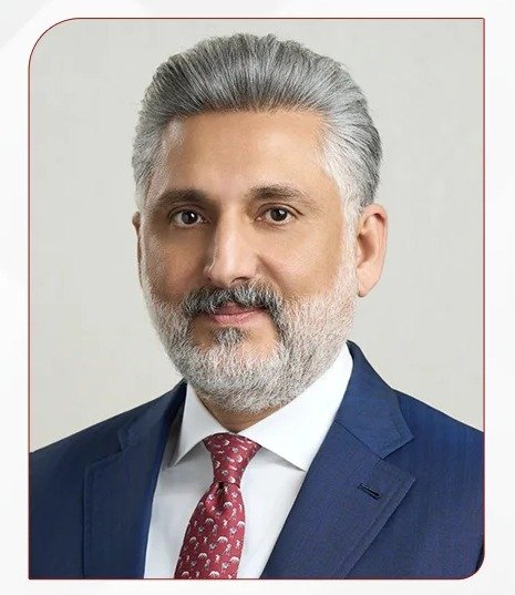 Portrait of BBK group chief executive Yaser Alsharifi in a dark suit and red tie