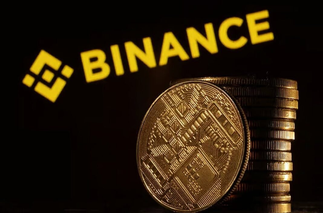 The Binance logo in yellow behind a stack of gold-colored coins with a circuit pattern