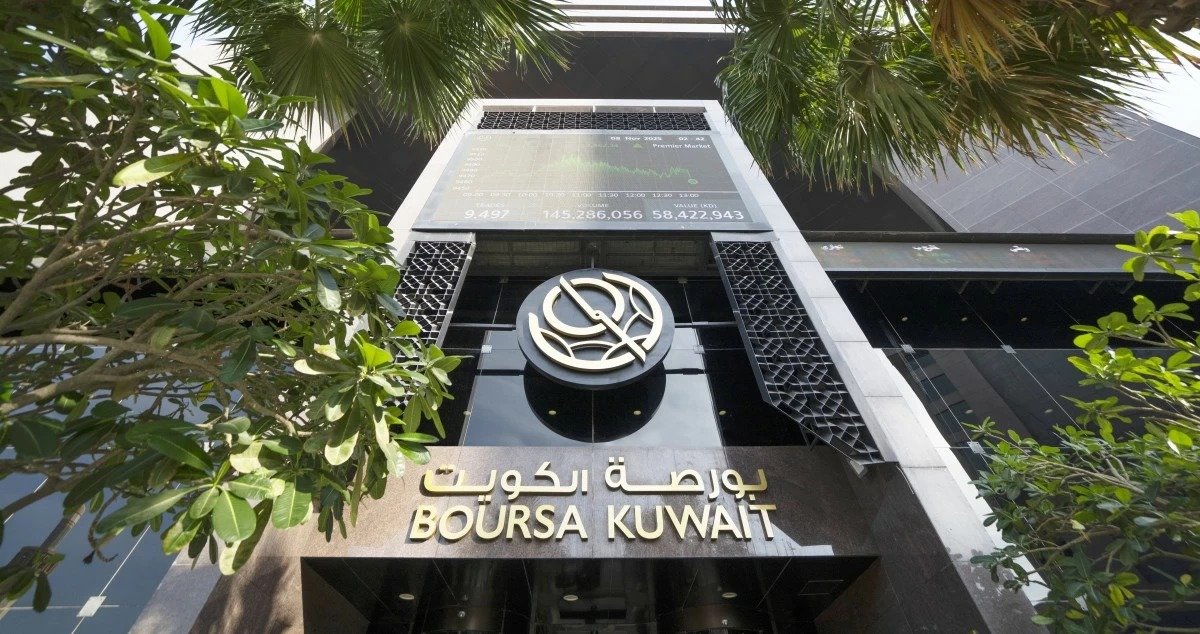The Boursa Kuwait headquarters building in Kuwait City, with a market data screen above the entrance