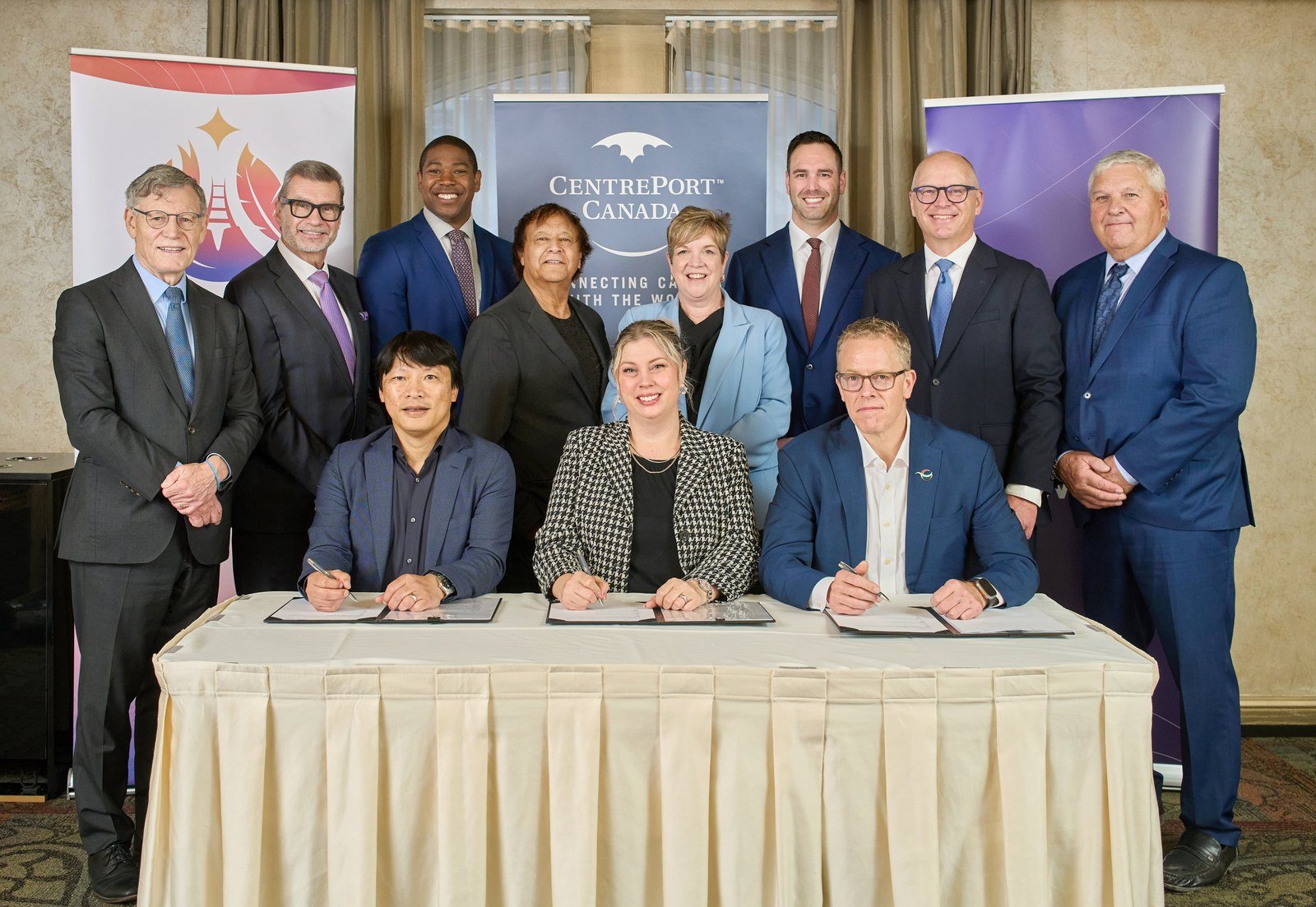 Representatives of Arctic Gateway Group, CentrePort Canada and DP World at a signing table