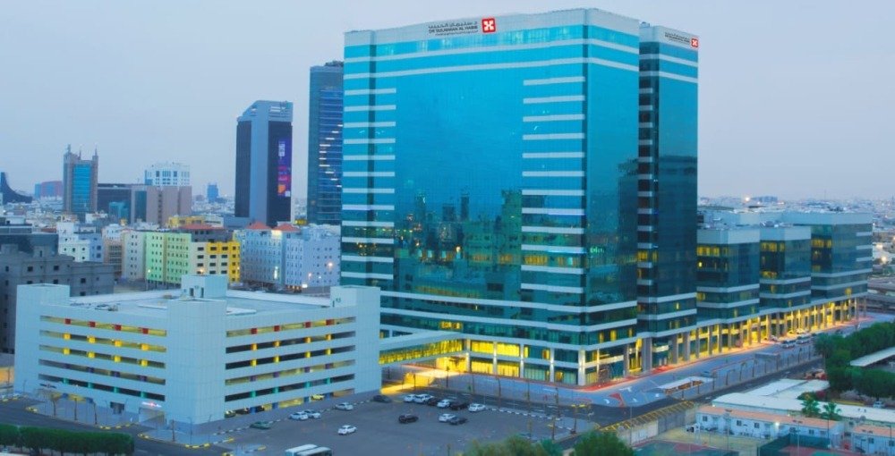Dr. Sulaiman Al Habib Medical Group hospital tower with a multistory parking building in the foreground