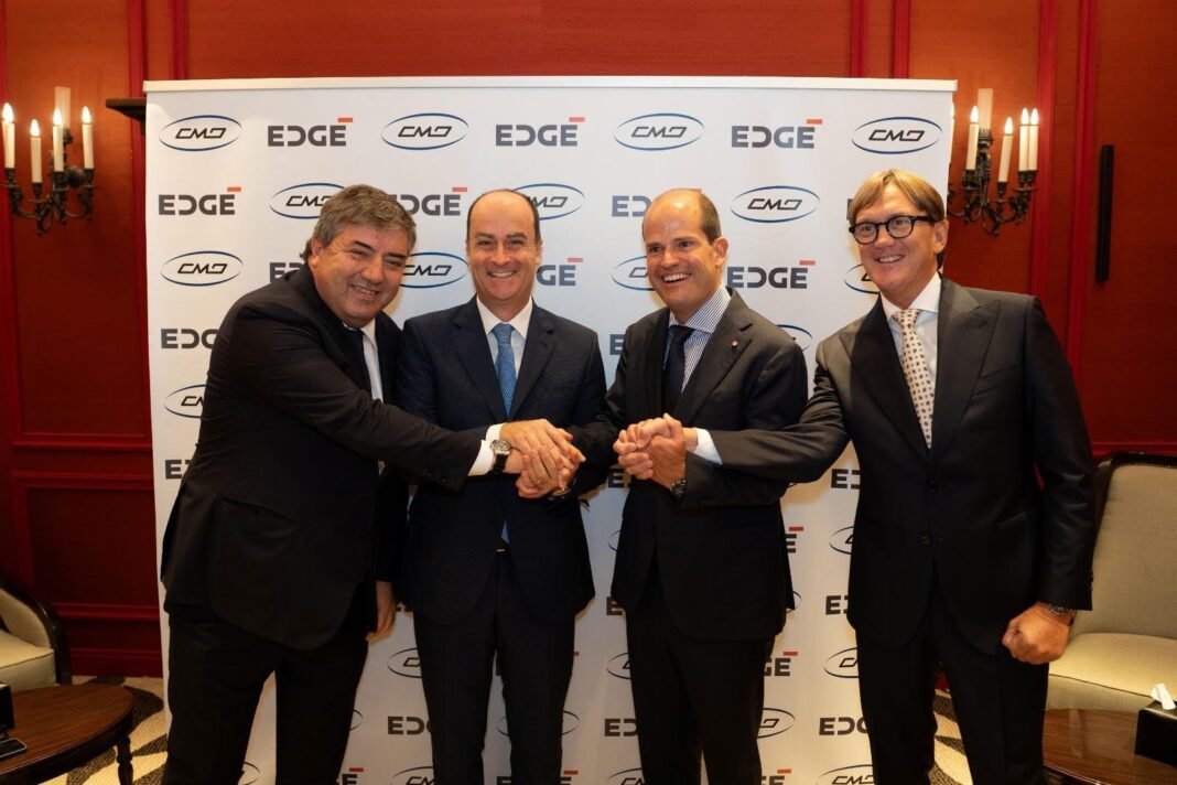 Executives from EDGE and CMD shake hands at a signing ceremony