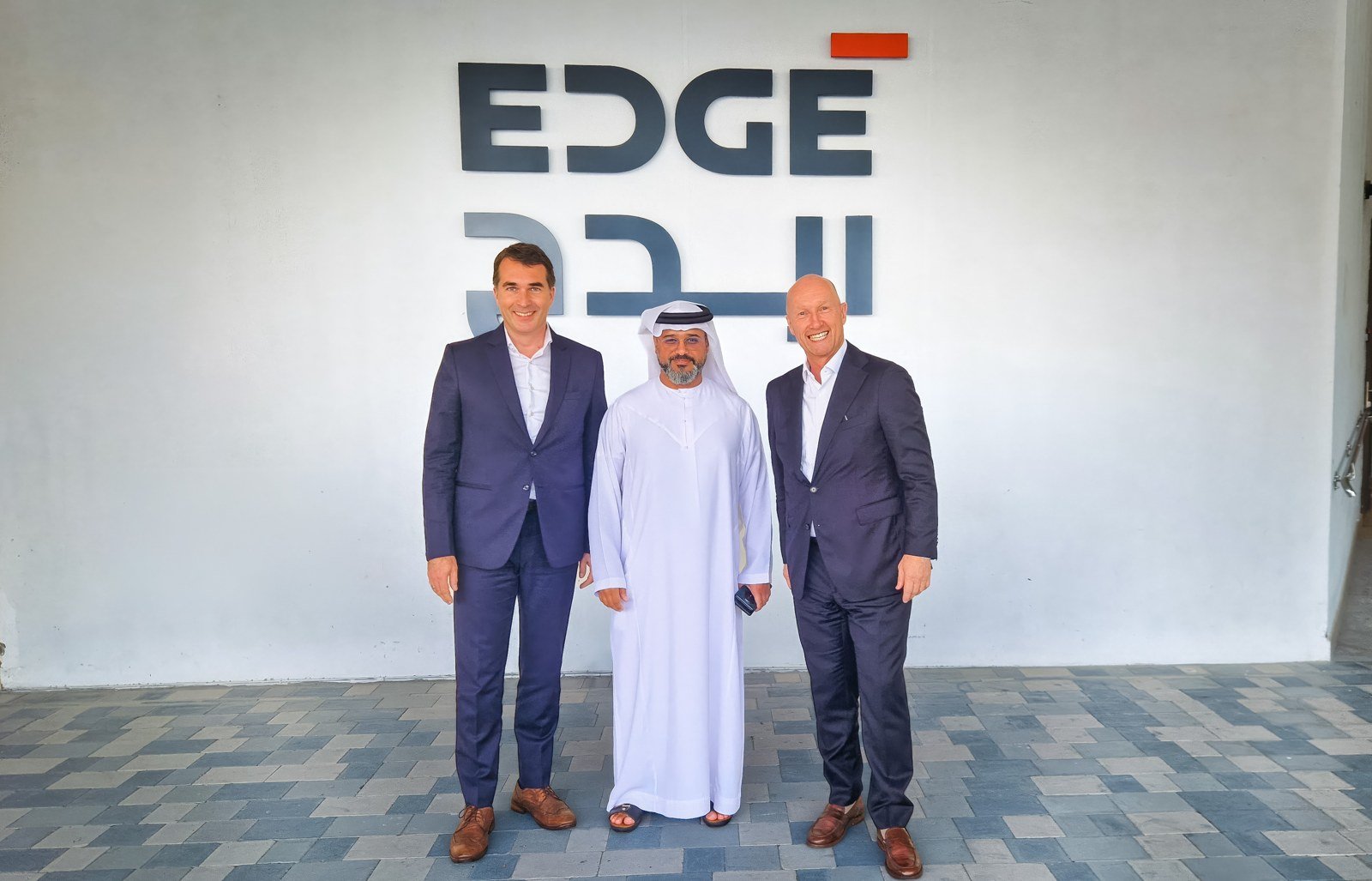 Executives from SFC Energy and EDGE in front of the EDGE sign in the UAE