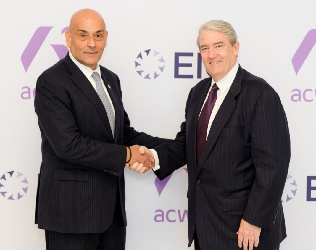 Acwa chief executive Samir J. Serhan shaking hands with EIG chief executive R. Blair Thomas in front of a backdrop bearing both company names