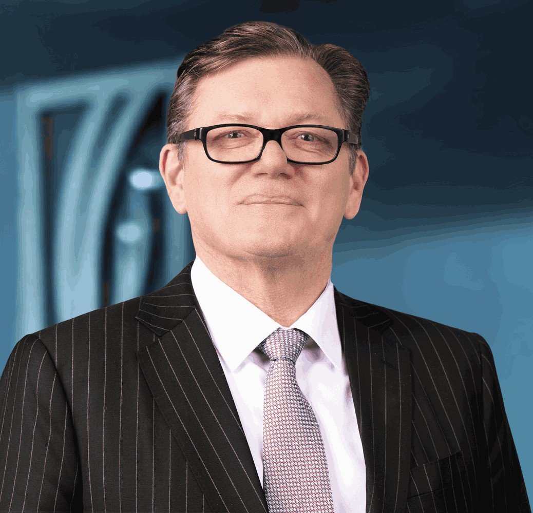 Emirates NBD Group Chief Executive Officer Shayne Nelson in a pinstripe suit and glasses
