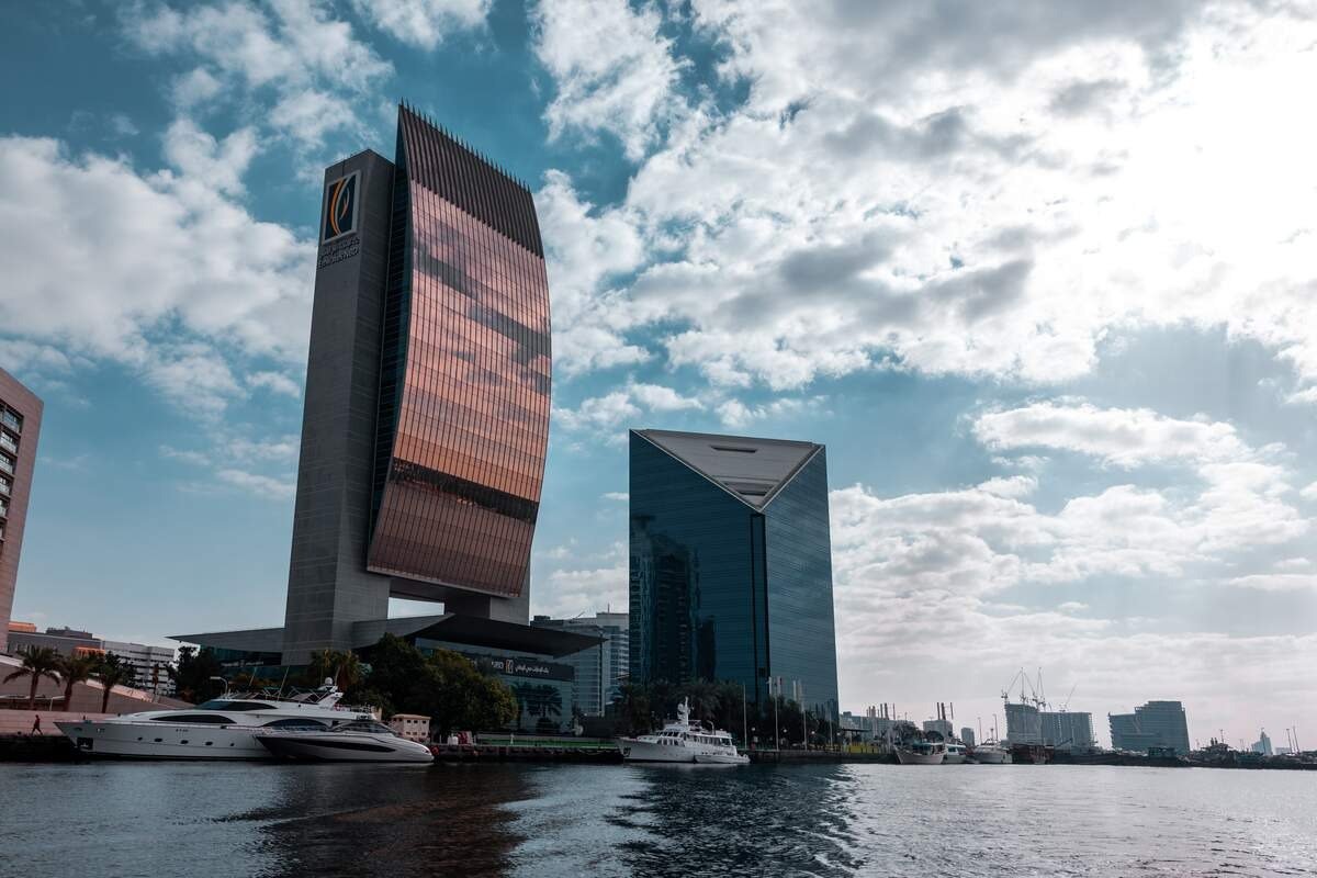 Emirates NBD and National Bank of Dubai towers on Dubai Creek with yachts docked in the foreground