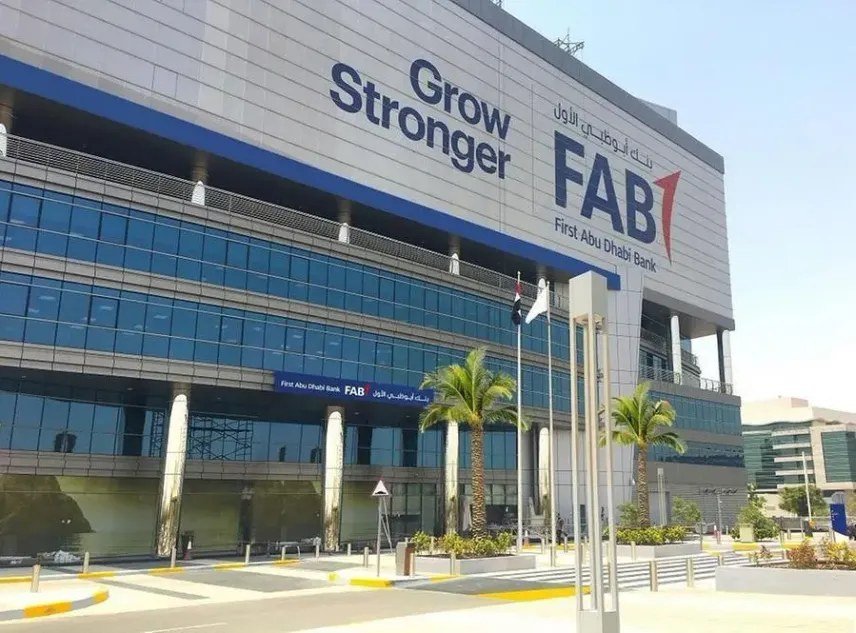 Exterior of a First Abu Dhabi Bank building in Abu Dhabi with the FAB logo and palm trees