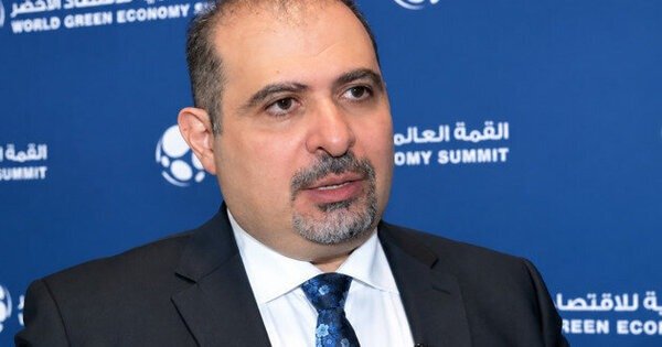 Bashar Al Natoor of Fitch Ratings speaking in front of a World Green Economy Summit backdrop