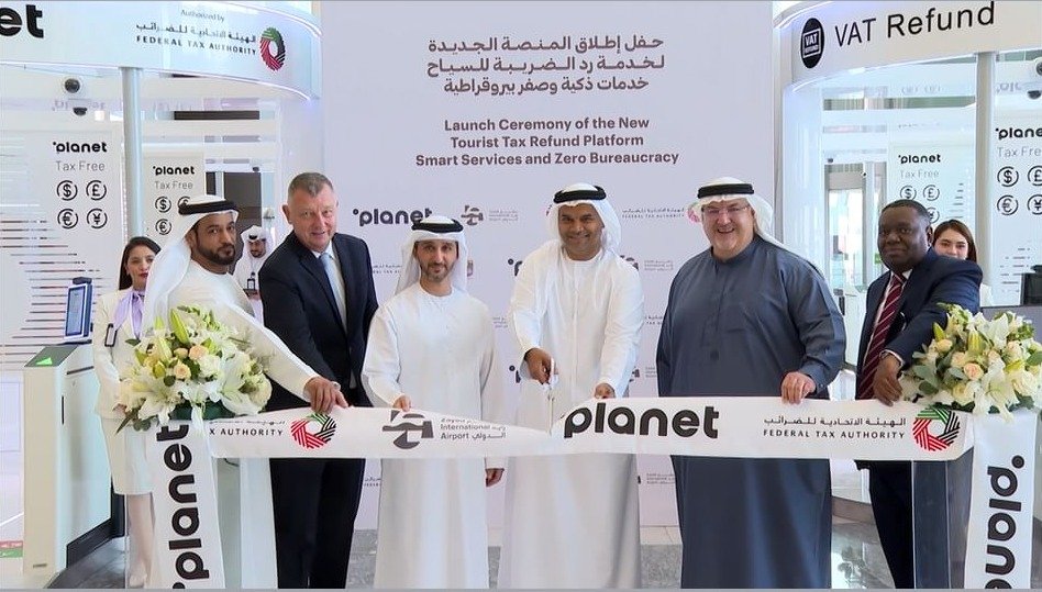 Officials cut a ribbon at a VAT refund counter during the launch of a tourist tax refund platform at Zayed International Airport