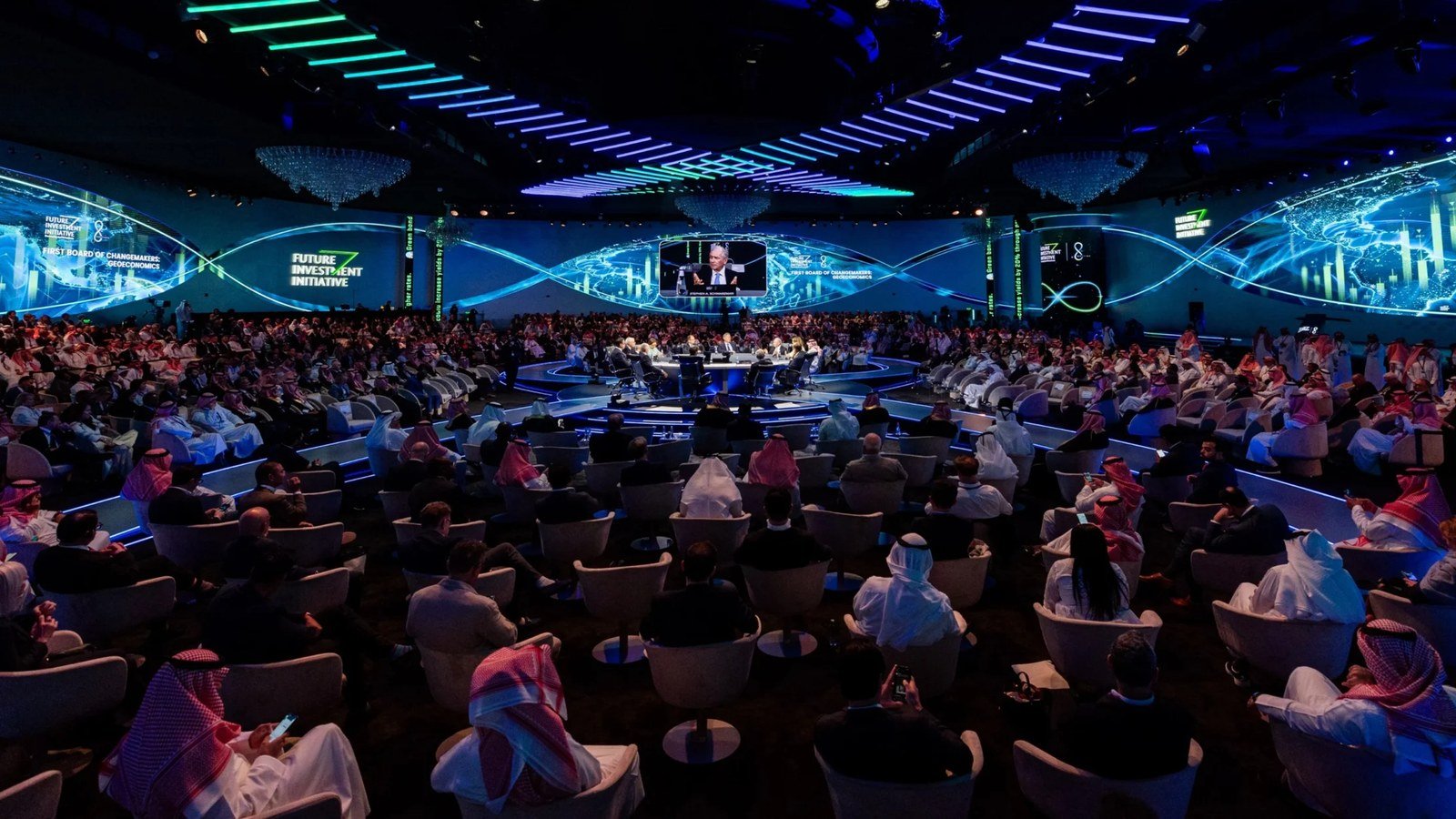 Wide view of a packed conference hall with large screens at the Future Investment Initiative in Riyadh