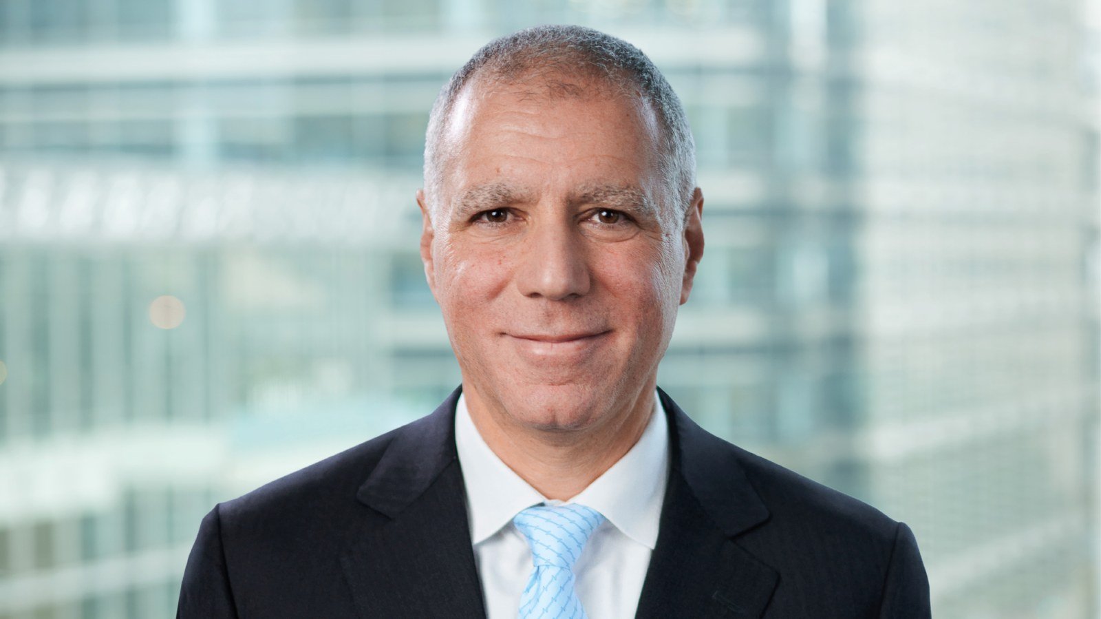 Portrait of HSBC Group Chief Executive Georges Elhedery in a dark suit and light blue tie