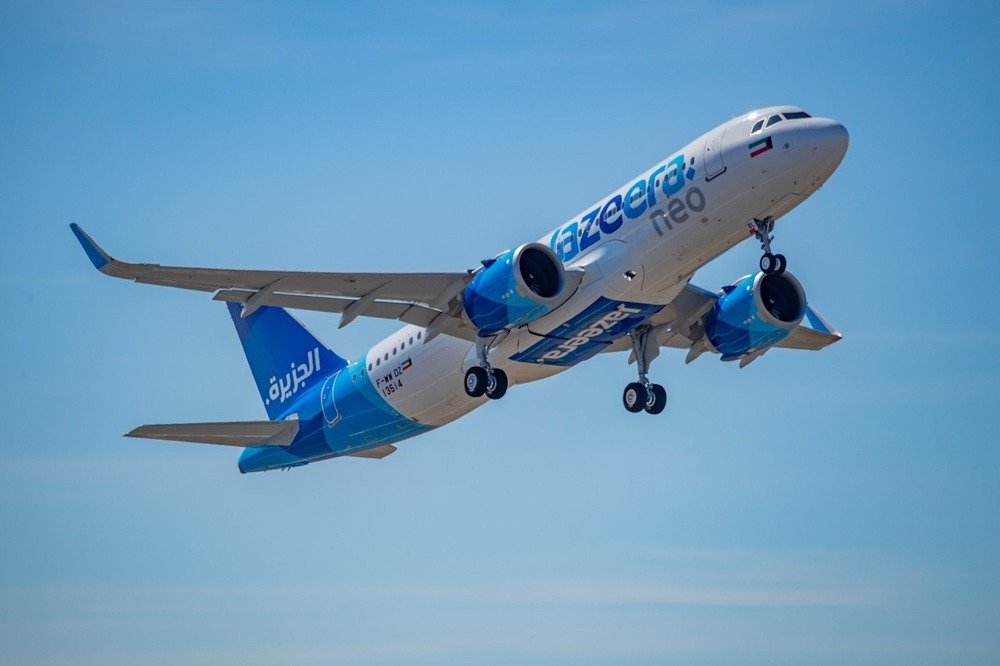 A Jazeera Airways Airbus A320neo aircraft in flight against a blue sky