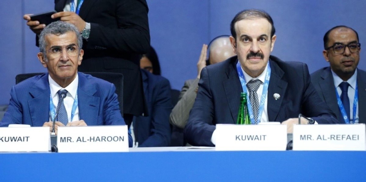 Kuwait's finance minister and central bank governor seated behind Kuwait name plates at an IMF meeting table