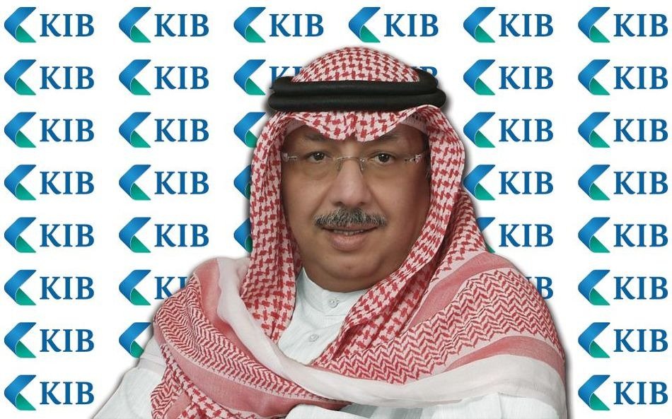 Portrait of Sheikh Mohammed Jarrah Al-Sabah, chairman of Kuwait International Bank, in a red and white ghutra in front of a KIB logo backdrop