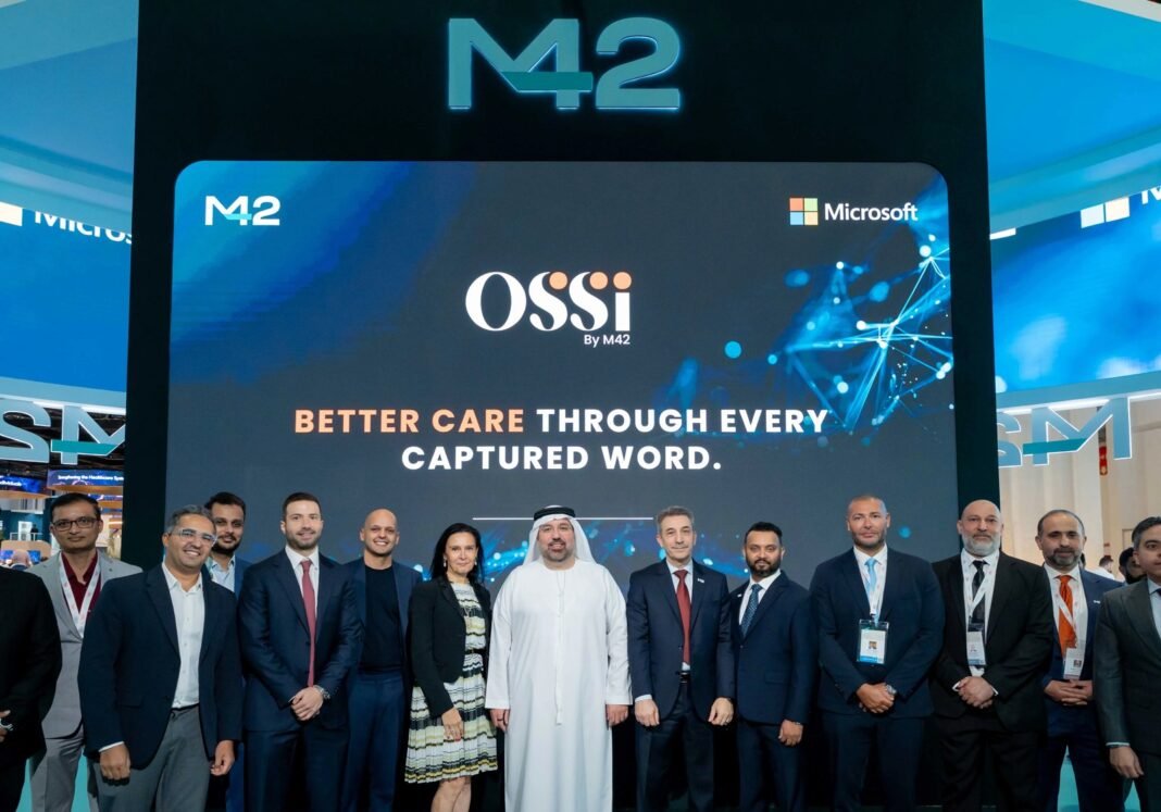 Group of executives standing in front of a large screen showing the Ossi by M42 platform and Microsoft logo at an exhibition stand
