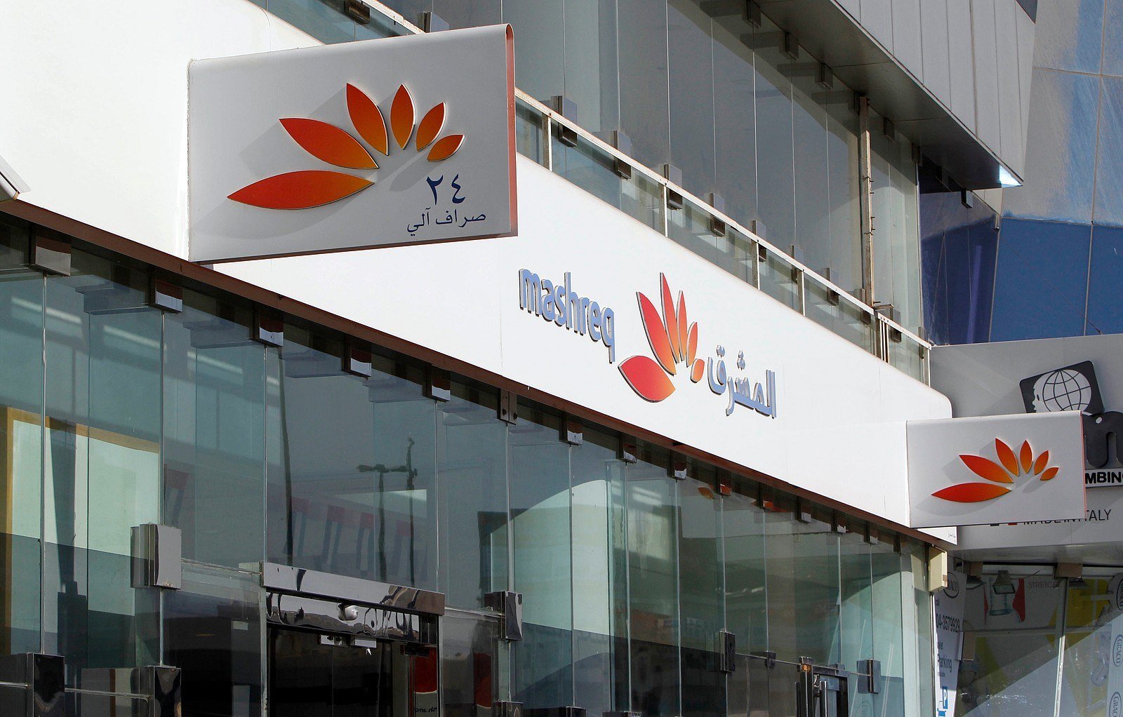 Mashreq bank branch facade with the bank logo in English and Arabic and an ATM sign