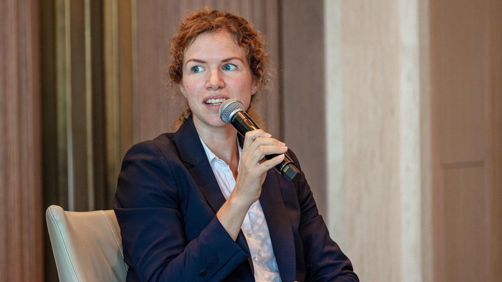 Nabta Health founder Sophie Smith speaking into a microphone while seated