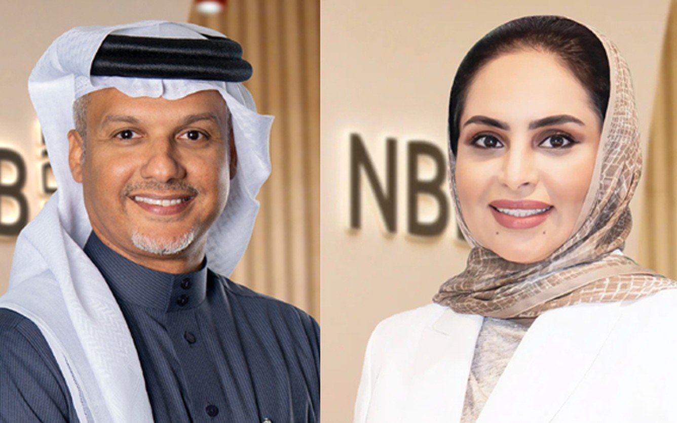 Portraits of National Bank of Bahrain executives Husain Almohri and Zaina Al Zayani in front of NBB signage