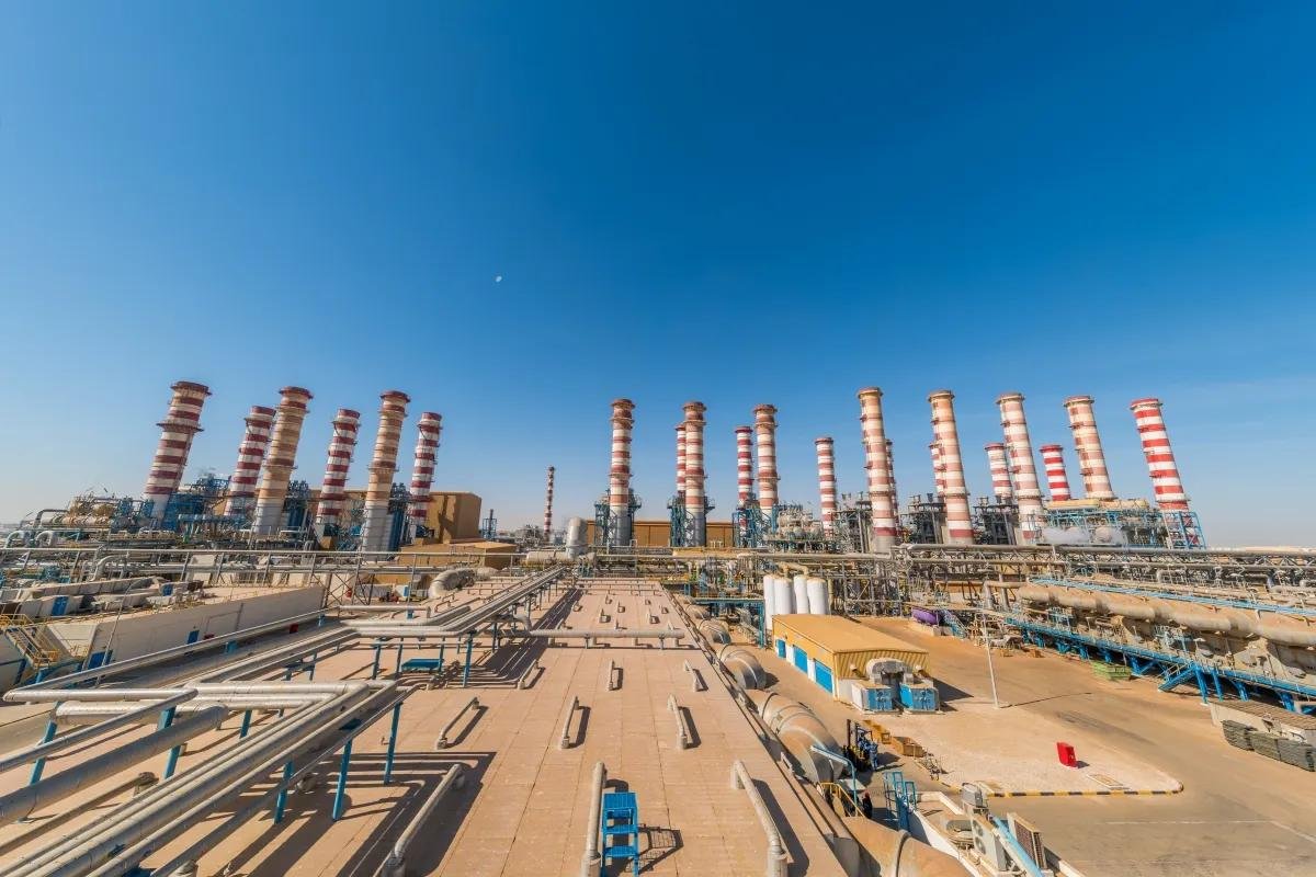 Exhaust stacks rise above a Nebras Energy power and water plant in Qatar