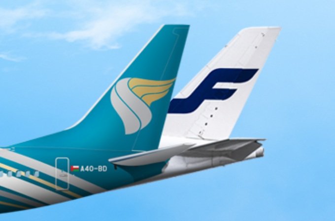 Tail fins of an Oman Air aircraft and a Finnair aircraft