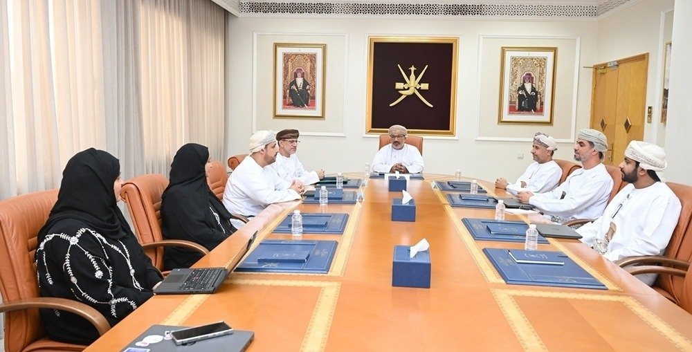 Members of Oman's Executive Committee for Local Content seated around a conference table during a meeting