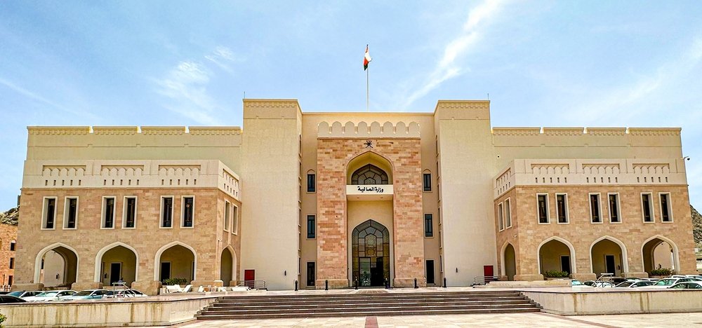 The Ministry of Finance building in Muscat, Oman, with the national flag flying above the entrance