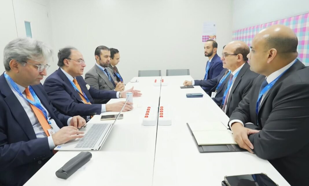 Pakistan's finance minister and officials seated across a meeting table from a Sharjah Islamic Bank delegation in Bangkok
