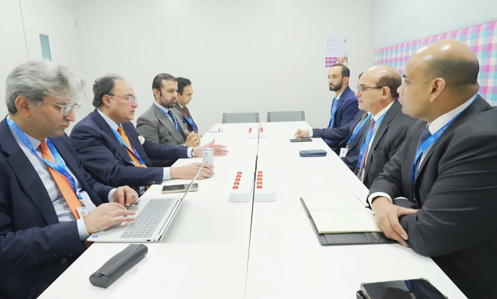 Pakistan's finance minister and officials seated across a meeting table from a Sharjah Islamic Bank delegation in Bangkok