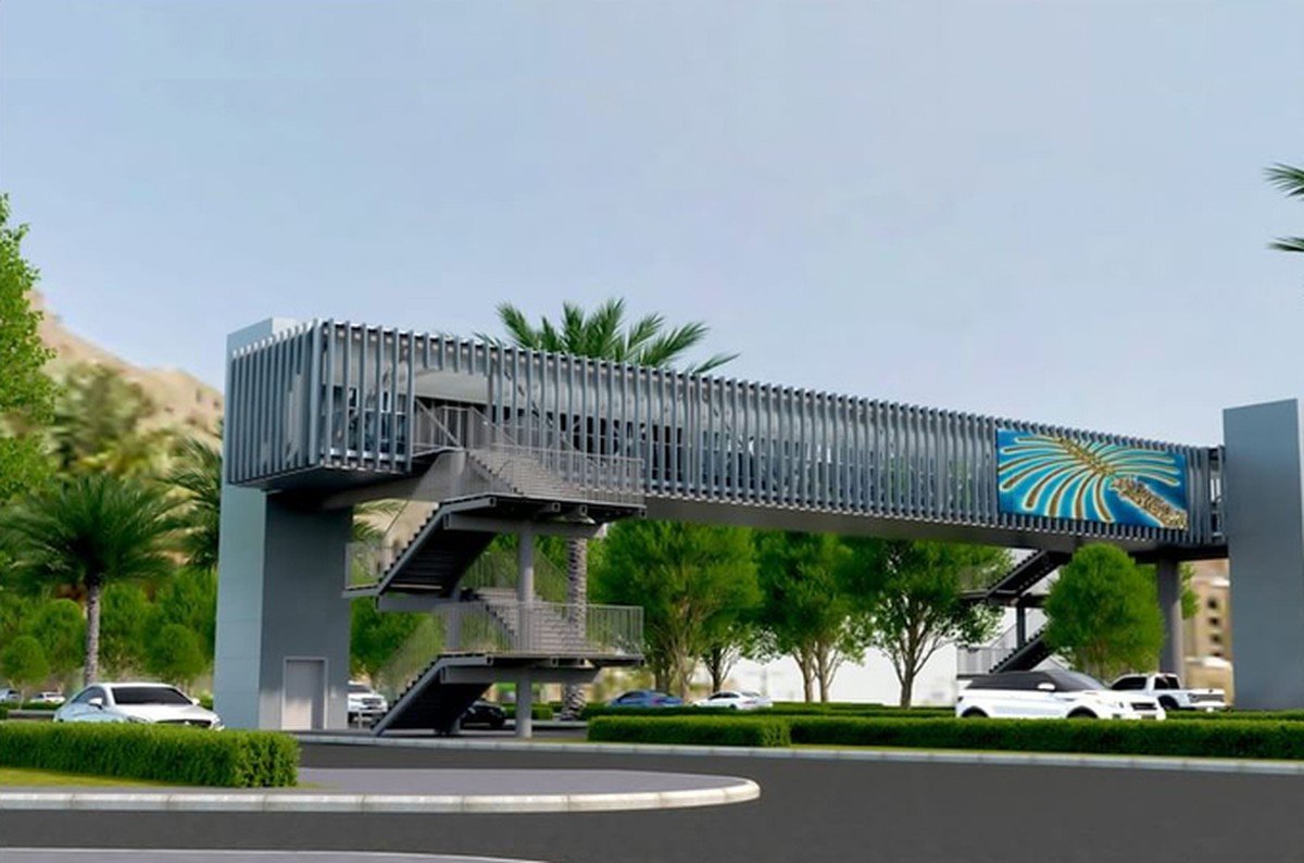 Design rendering of an enclosed pedestrian bridge with stair towers spanning a road lined with palm trees