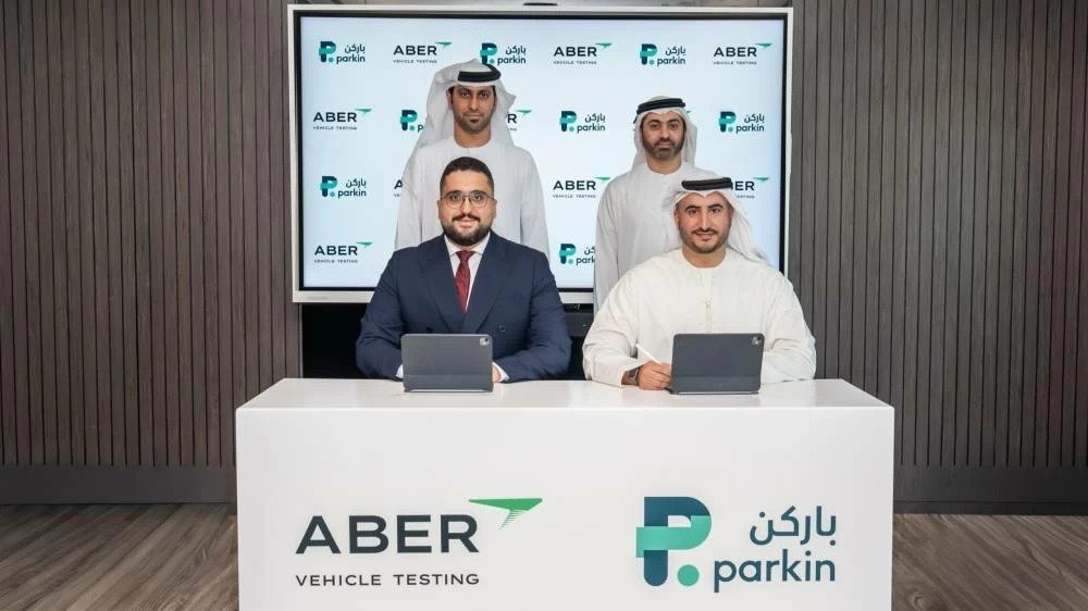 Officials from Parkin and Aber Vehicle Testing at a signing table in Dubai