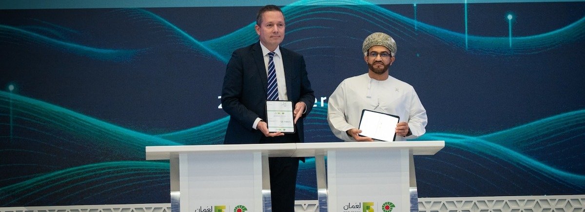 Officials hold signed tablets at a digital well construction contract signing ceremony held by Petroleum Development Oman