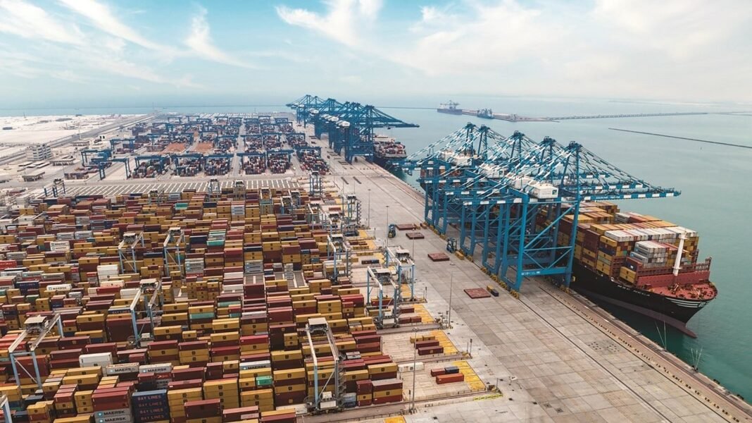Container cranes and stacked shipping containers at a port terminal