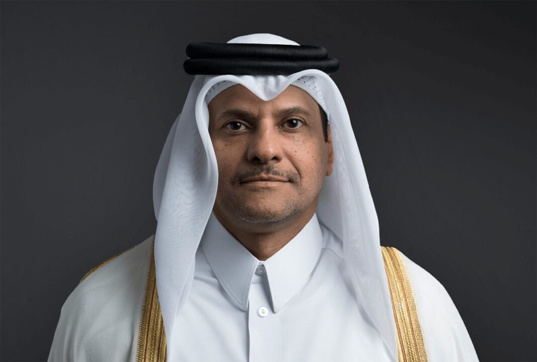 Official portrait of Sheikh Saoud bin Abdulrahman bin Hassan Al-Thani in a white thobe, ghutra and gold-trimmed bisht against a dark background