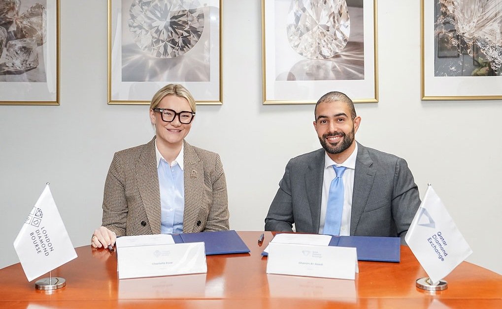 Charlotte Rose of the London Diamond Bourse and Ghanim Al Saadi of the Qatar Diamond Exchange seated at a signing table