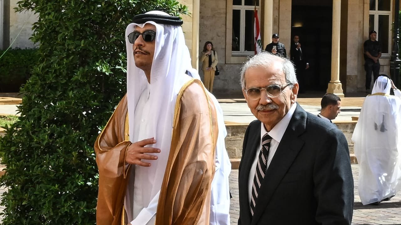 Qatar's Prime Minister in a brown bisht and Lebanon's Prime Minister Nawaf Salam in a dark suit outside the Governmental Palace in Beirut
