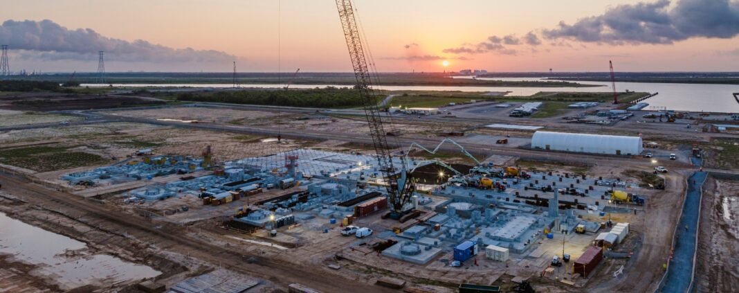 Aerial view of construction at Woodside's Louisiana LNG export plant site at sunset