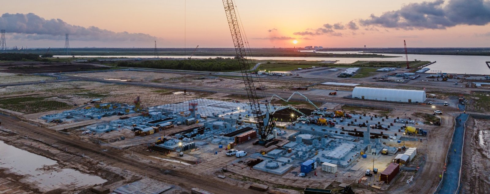 Aerial view of construction at Woodside's Louisiana LNG export plant site at sunset