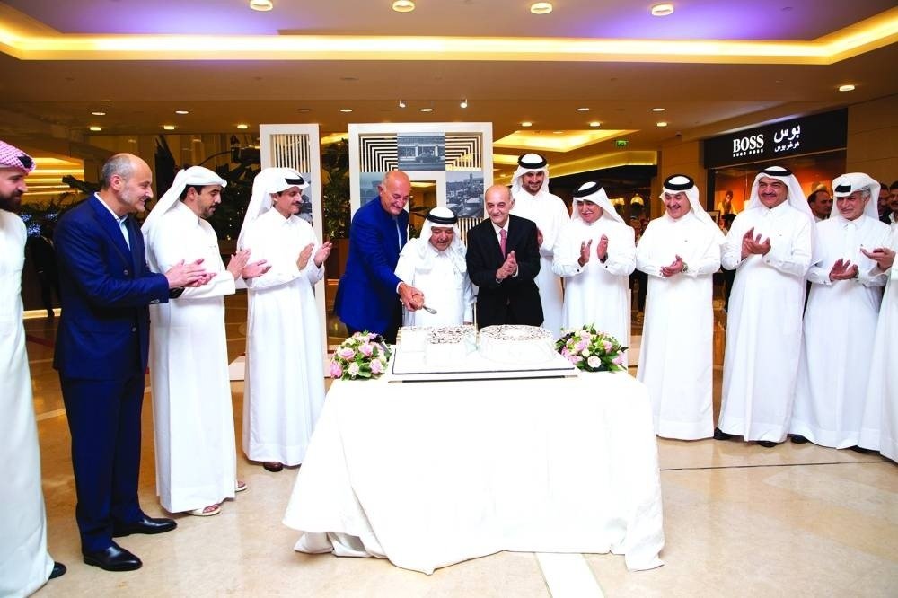 Salam International executives and guests cut a cake at the group's 70th anniversary celebration in Doha